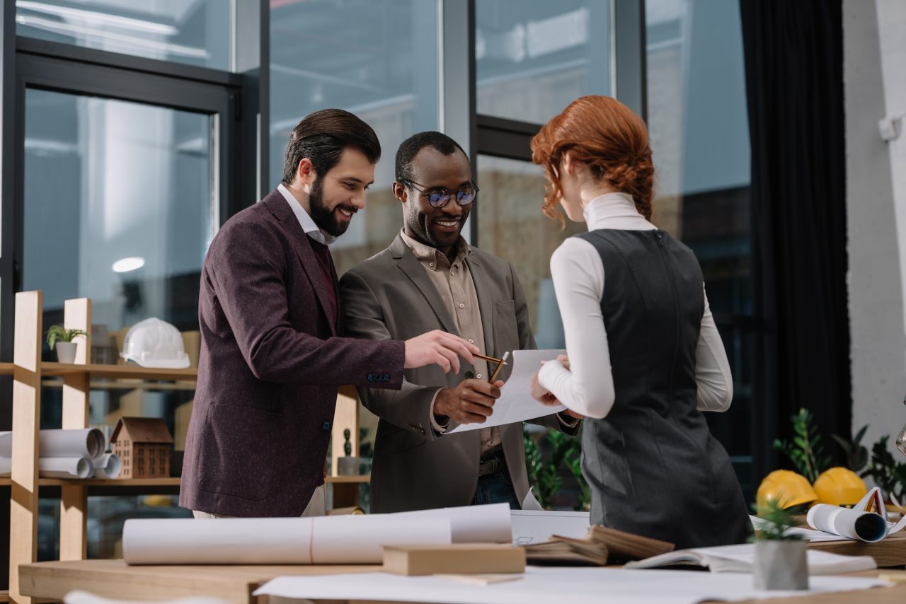 happy-multiethnic-team-of-architects-discussing-documets-at-office.jpg happy-multiethnic-team-of-architects-discussing-documets-at-office.jpg